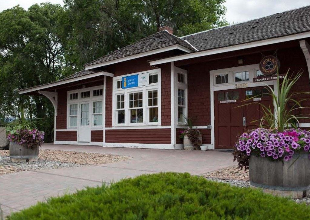 Brown building with white trim and a 'Visitor Centre' sign